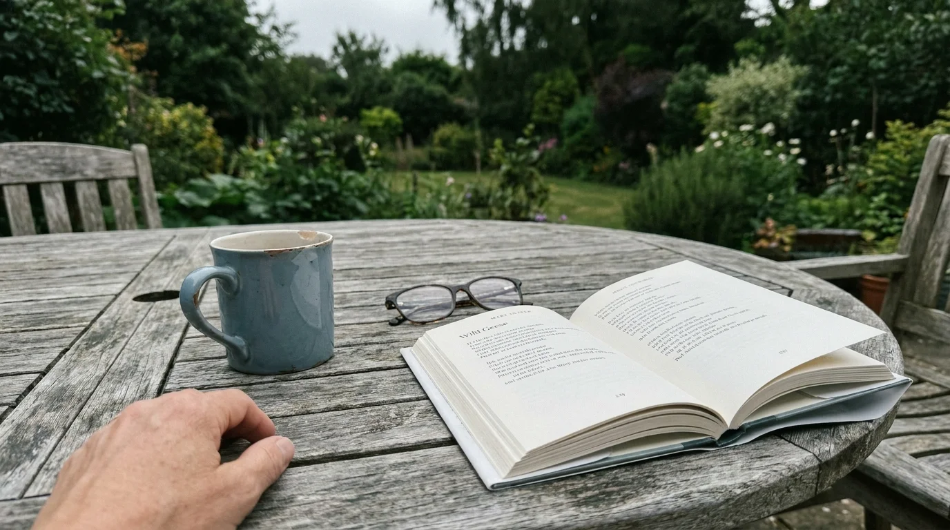 A coffee mug and a poetry book on a garden table at 10:30 AM, symbolizing a slower, redefined sense of productivity.